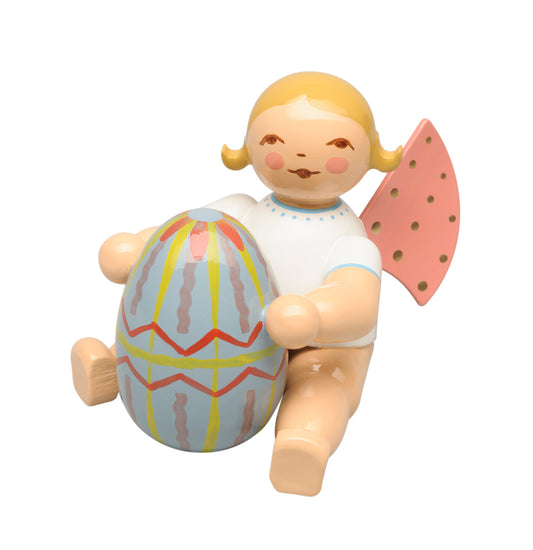 Angel with blue Easter egg, sitting